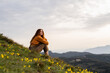 © Alba Vitta/Stocksy - Portrait of relaxed happy woman in nature at sunset