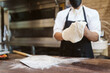 © Mal de Ojo Studio/Stocksy - Anonymous chef making a pizza dough