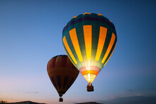 Hot Air Balloons Floating In The Air At Dawn