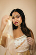 © Chloe  Sheldon/Stocksy - Woman Wearing Traditional Hindu Wedding Attire
