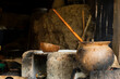 © Shava Cueva/Stocksy - Clay pot with a wooden stick inside next to a concrete comal