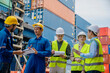 © karunyapas - Foremans are discussing for stack container at cargo site logistics service transportation. Import export concept.