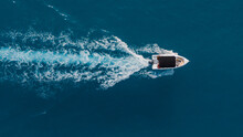Close-up Drone View Of A Boat With Tourists Speeding In Azure Water