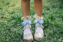 A Child Wearing Daisies In Her Socks