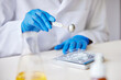 © ALTO IMAGES/Stocksy - Faceless specialist weighing chemical ingredient