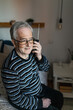 © Lupe Rodríguez/Stocksy - Senior man with vitiligo listening to the radio sitting on the bed