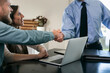 © Sean Locke/Stocksy - Couple Shakes Hands With Financial Advisor At Home