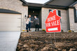 © Sean Locke/Stocksy - Focus On Sign As Agent Meets Buyers