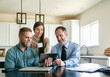© Sean Locke/Stocksy - Couple Meets With Financial Advisor At Home