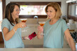 © Albert Martinez/Stocksy - Women with cocktails in kitchen