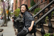 © Lauren Lee/Stocksy - Portrait of woman in neighborhood
