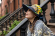 © Lauren Lee/Stocksy - Smiling woman on stoop
