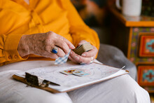 Crop Senior Woman Reading Cards