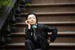 © Lauren Lee/Stocksy - Woman sitting on her stoop