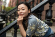 © Lauren Lee/Stocksy - Portrait of woman sitting on stoop