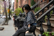 © Lauren Lee/Stocksy - Woman on pretty residential street