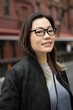 © Lauren Lee/Stocksy - Portrait of woman in glasses on the go