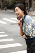 © Lauren Lee/Stocksy - Happy woman laughing in street