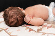 © Leonardo Borges/Stocksy - newborn baby unrecognizable in bed