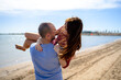 © Albert Martinez/Stocksy - Loving happy guy carrying girlfriend on sandy beach