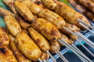 A tray of Banana cue for sale a a food stall. Delicious and sweet street food snack.