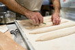 © Javier Díez/Stocksy - Crop man making baguettes from dough