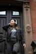 © Lauren Lee/Stocksy - Woman leaving house with headphones