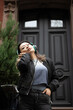 © Lauren Lee/Stocksy - Woman with headphones leaving house