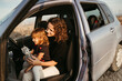 © Irina Polonina/Stocksy - Mother with  little daughter traveling by car.