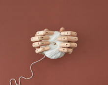 Artificial Mannequin's Hands Hold The Ball Of Thread.
