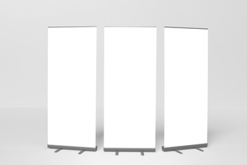 Wall Mural - Blank white three roll-up banner display mockup, isolated, 3d rendering.