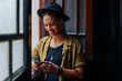 © VICTOR TORRES/Stocksy - Smiling woman texting with smartphone