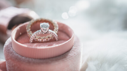 Wall Mural - Close up of diamond ring in the pink box with sunlight and shadow. Love, valentine, relationship and wedding concept. Soft and selective focus.