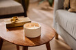 © Martí Sans/Stocksy - Ceramic cup with candle near box