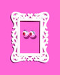 Funny eyeballs, false lushes and vintage style frame, creative arrangement on hot pink background. Girly flirting creative layout. 