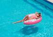 © lavju83 - young girl in a bathing suit relaxing on inflatable rubber ring  in swimming pool. Enjoying summer. Vacation mood