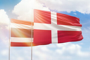 Sunny blue sky and flags of denmark and thailand