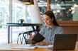 © crizzystudio - Portrait of beautiful asian woman working financial report with laptop computer at office.