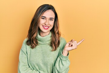 Poster - Young hispanic girl wearing casual clothes smiling happy pointing with hand and finger to the side