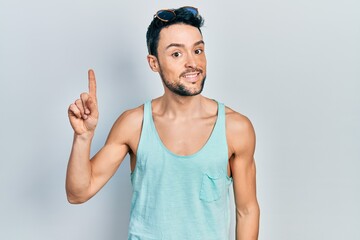 Poster - Young hispanic man wearing summer style smiling with an idea or question pointing finger up with happy face, number one