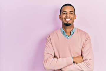 Young african american man wearing elegant clothes happy face smiling with crossed arms looking at the camera. positive person.