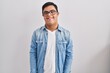 canvas print picture - Young hispanic man with down syndrome wearing casual denim jacket over white background with a happy and cool smile on face. lucky person.
