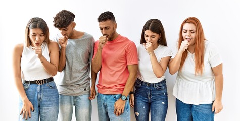 Poster - Group of young friends standing together over isolated background feeling unwell and coughing as symptom for cold or bronchitis. health care concept.