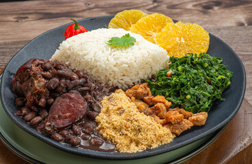 feijoada: typical and traditional brazilian cuisine, paired with caipirinha and beer.