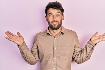 Poster - Handsome man with beard wearing casual shirt clueless and confused with open arms, no idea and doubtful face.