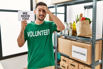 Sticker - Young hispanic man wearing volunteer t shirt holding we need you banner stressed and frustrated with hand on head, surprised and angry face