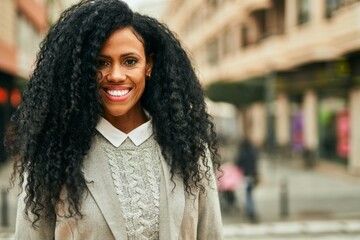 Sticker - Middle age african american businesswoman smiling happy standing at the city.