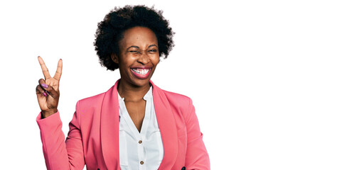 Canvas Print - African american woman with afro hair wearing business jacket smiling with happy face winking at the camera doing victory sign with fingers. number two.