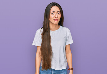 Poster - Young hispanic girl wearing casual white t shirt skeptic and nervous, frowning upset because of problem. negative person.