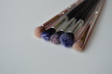 Poster - Professional cosmetic makeup brushes of different sizes on a white background for applying powder, shadows and blush and other cosmetic products